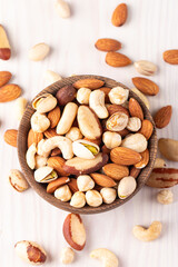Healthy mix nuts on wooden background. Almonds, hazelnuts, cashews, peanuts, pistachios, Brazil nuts