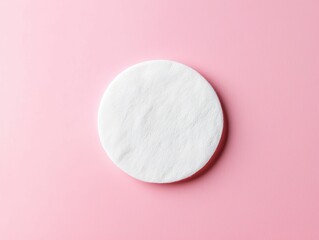 Close-up of a cotton pad with toner, part of a fresh, minimalist skincare routine