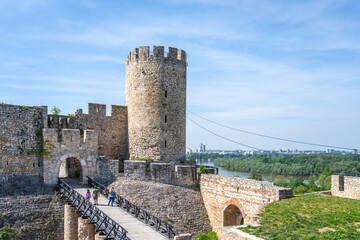 Visitors explore Despots Gate and Dizdar Tower at Belgrade Fortress, enjoying panoramic views of the river and cityscape on a sunny day in Serbia's capital.