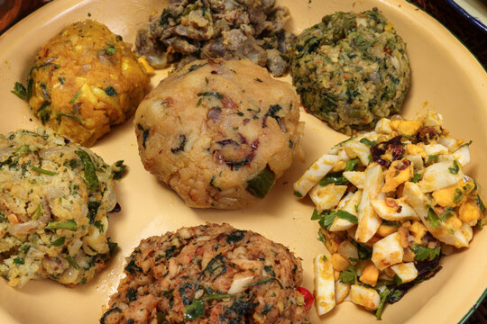 Bengali style spread verity vorta mashed bhorta potato egg brinjal shrimp prawn fish chicken liver on rustic metal tin plate