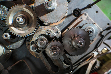 A close-up of industrial metal gears showcases precision engineering and mechanical design. The...