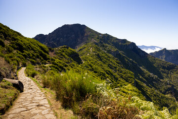 Fototapeta premium Hiking trail in the mountains of Pico Ruivo in a sunny day. Madeira island, Portugal