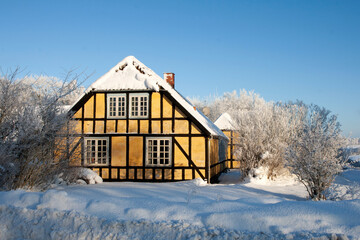 Yellow half-timbered House in the snow