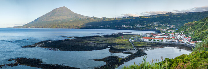 Panoramic view of Fishing village Lajes do Pico with Volcano Mount Pico in background in morning...