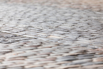 Variable focus shot of cobbled street paving, useful for concept or background for graphics
