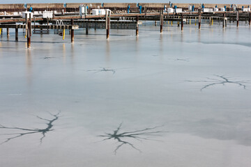 Small cracks opening within the harbor water of the Port Washington, Wisconsin harbor in early spring