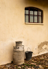 milk can outside a old barn