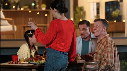 Family gather celebrate holiday. Parents, grandparents and cute girl together talk and have dinner...