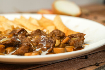 Delicious Beef Stew with Creamy Sauce and Golden French Fries