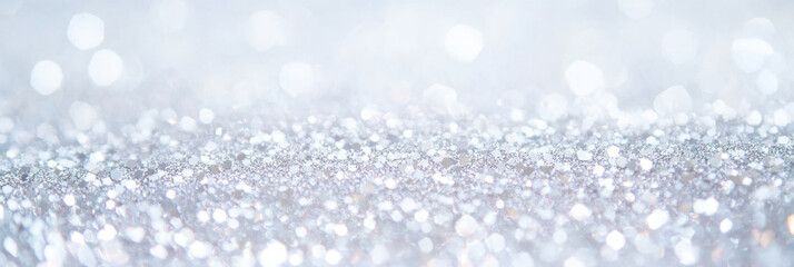 A shimmering background of silver glitter creates magical and festive atmosphere, perfect for celebrations and special occasions. sparkling effect adds elegance and charm to any design
