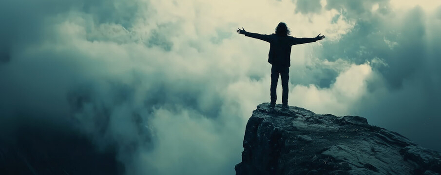 A lone figure stands on the edge of a cliff with arms outstretched, embracing the vastness of the sky and clouds below, symbolizing freedom, fearlessness, and connection with the natural world