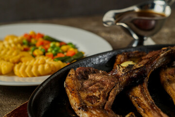 Close-up of Grilled Lamb Chops with Side Dish