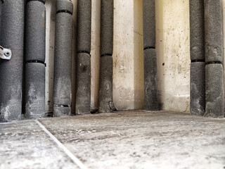 Pipes insulated along a wall in a residential building, highlighting maintenance and infrastructure...