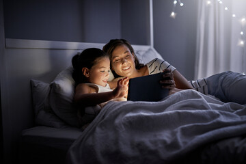 Mother, child and tablet in bedroom at night for streaming cartoon, playing games and storytelling...