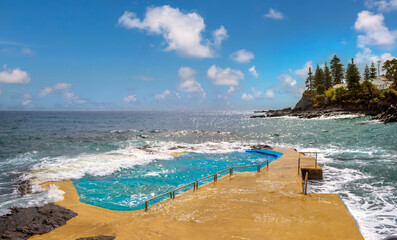 Fascinating public salt water pool among the rough waves  of the Atlantic ocean on the south coast...