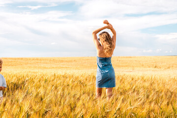 Russia, Republic of Tatarstan, Kalmash village, August 01, 2024, 17:00, girl in a dress in a wheat field in summer