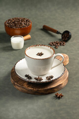 Indian Chai Tea Latte with Star Anise: A ceramic cup of chai tea latte, topped with star anise for...