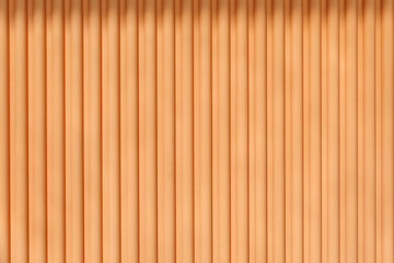 Soft orange-striped wall with vertical lines in a modern interior design setting