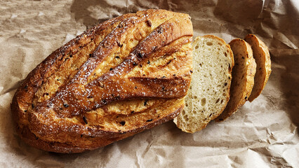 Close up of freshly baked delicious organic homemade wholemeal bread with crispy crust and cut...