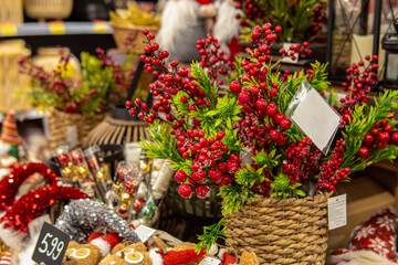 Sale of Christmas decor in the store. Christmas tree toys and fir branches with berries