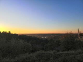 Gentle sunset view from the mountain in the forest to the forest
