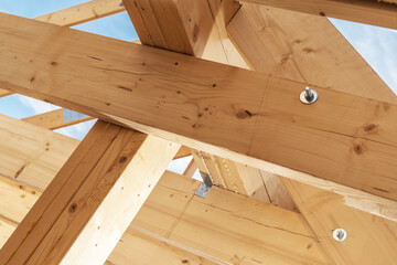 Construction of a Wooden Framework for a Building Under Clear Blue Skies in Daytime