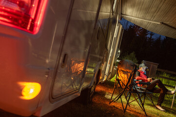 Relaxing at Dusk Next to a Cozy Camper in the Peaceful Wilderness