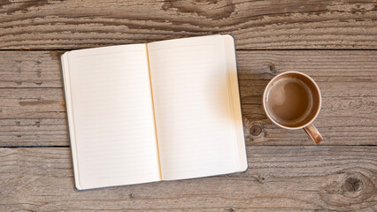Notebook on a wooden background, spiral notepad and coffee on a table