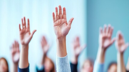 Hands raised in a group setting, signaling participation and engagement.