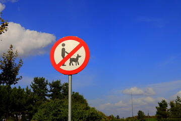 No Dog Walking Sign, Dogs not allowed, Round Sign in Park