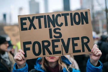 Extinction Is Forever sign at environmental protest &ndash; climate change activism and biodiversity conservation message	