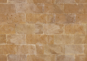 Fototapeta premium Seamless beige stone wall texture with natural patterns and subtle variations in tone