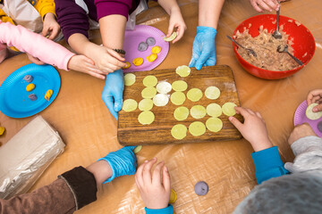 A group of people making homemade dumplings together. Ideal for teamwork, cooking workshops, family activities, and traditional recipes