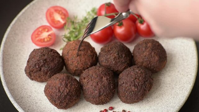 Falafel vegetarian and vegan dish made with chickpeas, spices and herbs on a dark concrete background