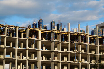 Fototapeta premium Unfinished construction of dwelling house. New reinforced concrete building