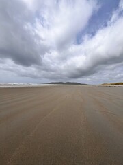 beach and sea with a hint of the rolling hills and sand dunes Ireland co Donegal