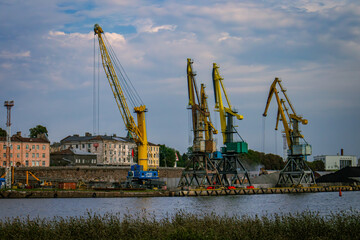Cranes on the embankment. Unloading coal