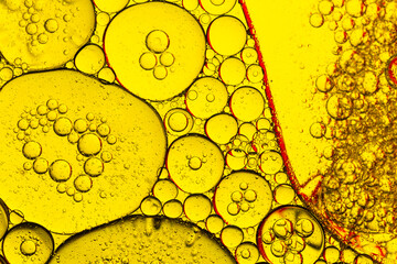 Yellow and red macro bubbles,Beautiful cosmetic background. Golden orange yellow abstract oil...