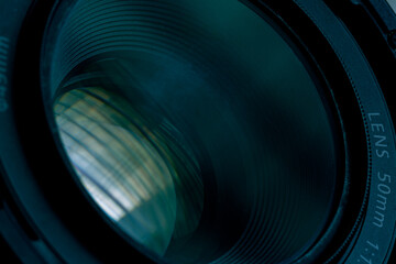 50mm camera lens,Top view of a professional optical lens for modern DSLR cameras isolated on a black background. High resolution image.