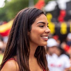 Obraz premium brazilian woman with red hair in a red dress with her face in a park