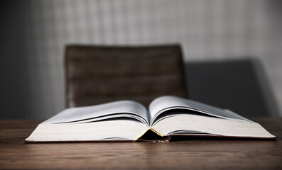 open book on wooden desk background