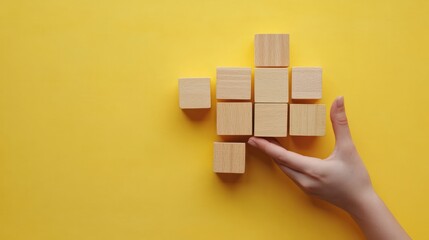 Business process and workflow automation with flowchart. Hand holding wooden cube block arranging processing management on yellow background