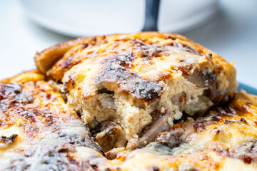 Traditional French pie. Quiche Loren on a white kitchen table.