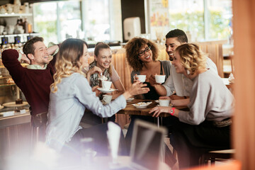 Group of young people enjoying a coffee in a cafe