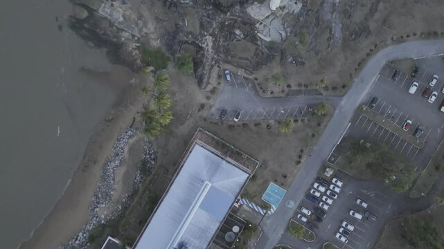 Drone flies with camera down over Pointe Des Roches after sunset in Kourou, French Guiana, France