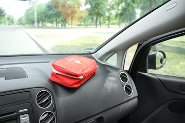 Obraz premium First aid kit on car dashboard