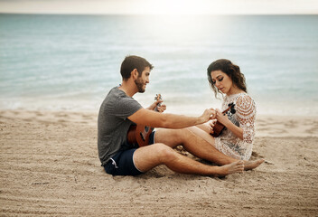 Fototapeta premium Couple, travel and learning at ocean with ukulele, music and help with tutorial. Musician man, woman and instruments on beach for musical advice, summer vacation and tuning on holiday in Maldives