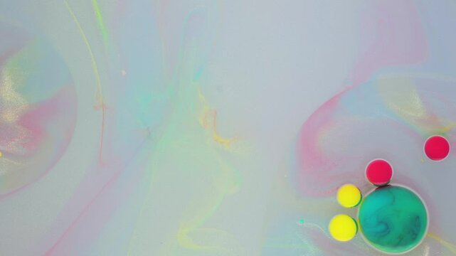 Creating colorful bubble art using soap, water, and vibrant dyes in a playful indoor setting