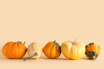 Fresh pumpkins on beige background