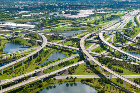 Massive highway intersection in American city area. Stacked elevated interchange lanes for express passing of car traffic. Miami, Florida